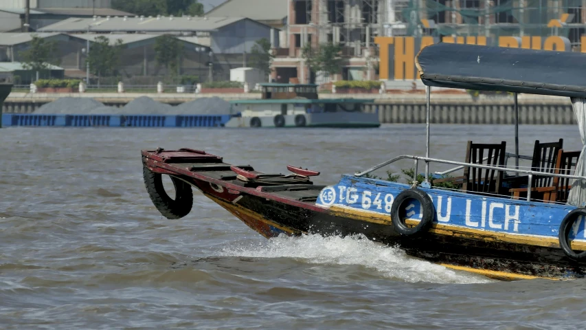 a black and blue boat with wheels going down the water