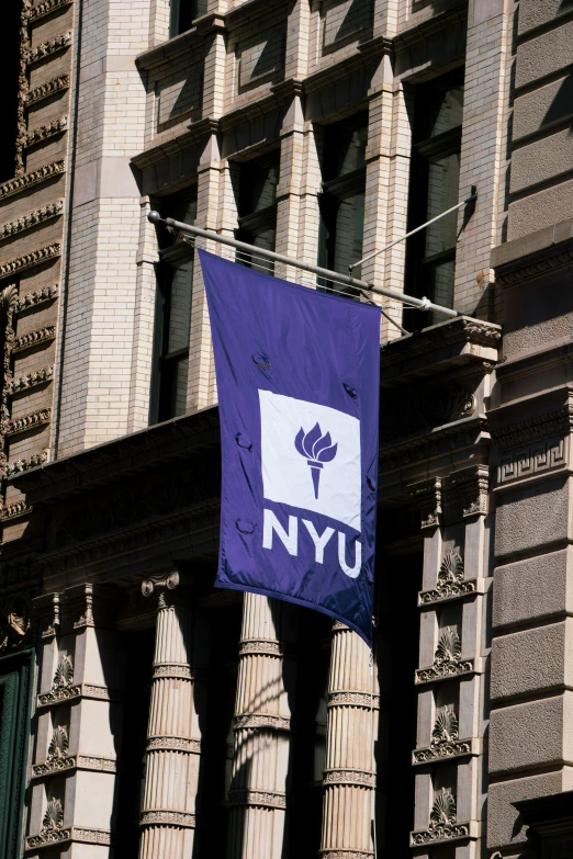 an nyc flag on the side of a building in a city