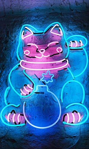 a lit sign of a kitty holding a pot with money