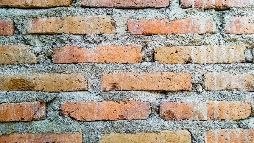 brick wall textured with gray dirt and rust