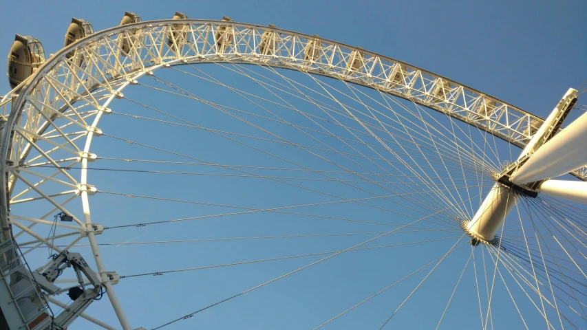 the big wheel is next to a boat floating on the water