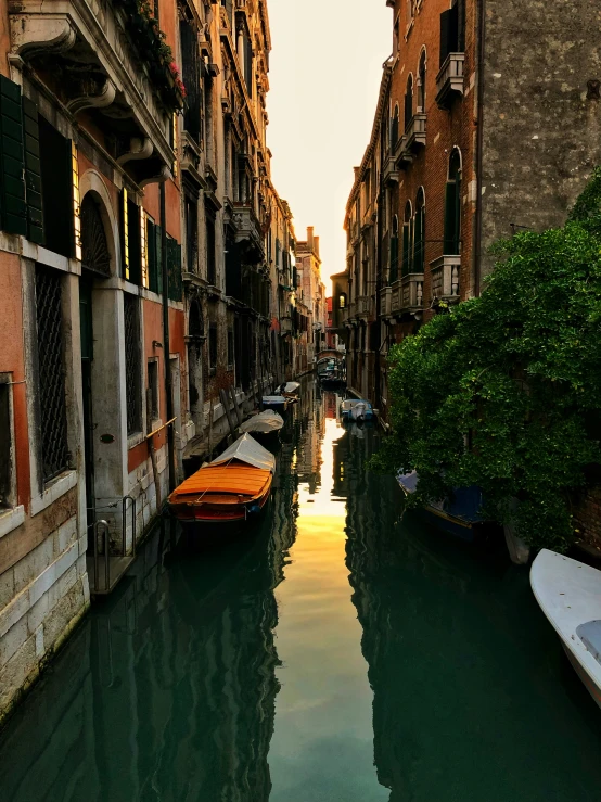 a narrow river filled with water surrounded by buildings