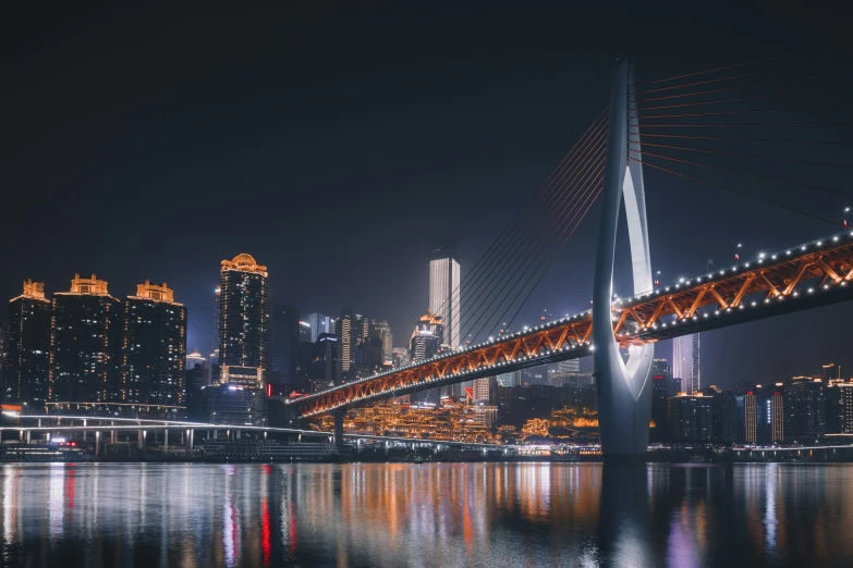 a very long bridge spanning across a city at night