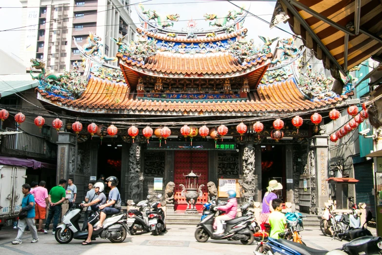 motorcycles are lined up and parked in front of a small temple