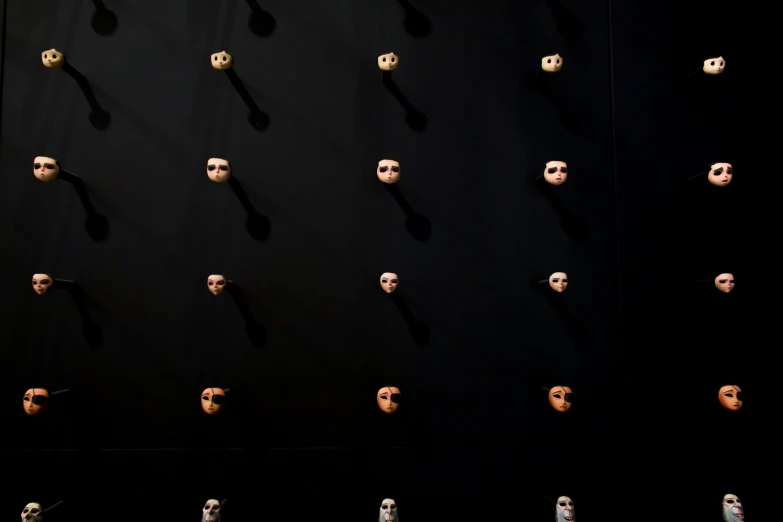 the wall has a pattern of different types and sizes of skull heads on it