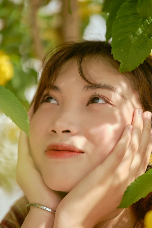 a woman is posing for a picture under leaves