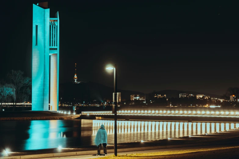 a tall white clock tower in the middle of a town