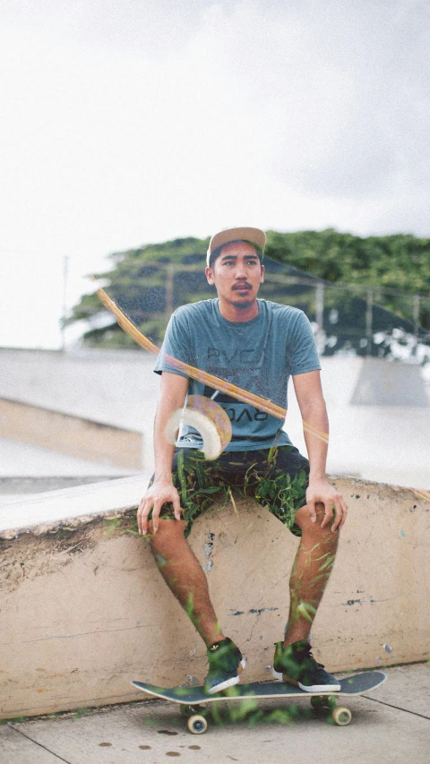 a man sitting on top of a cement wall