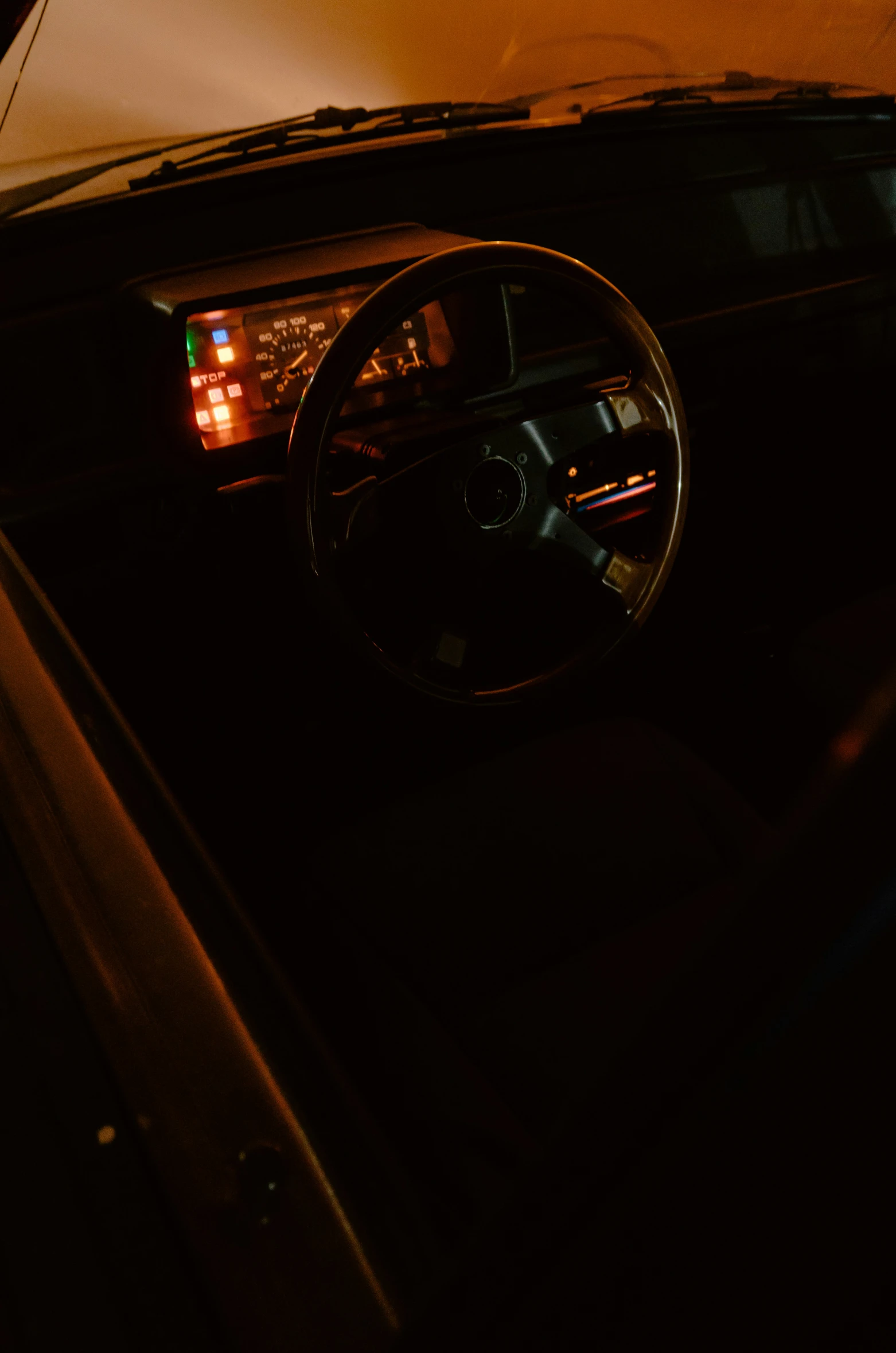 an older vehicle with two lights on and dashboard mirror