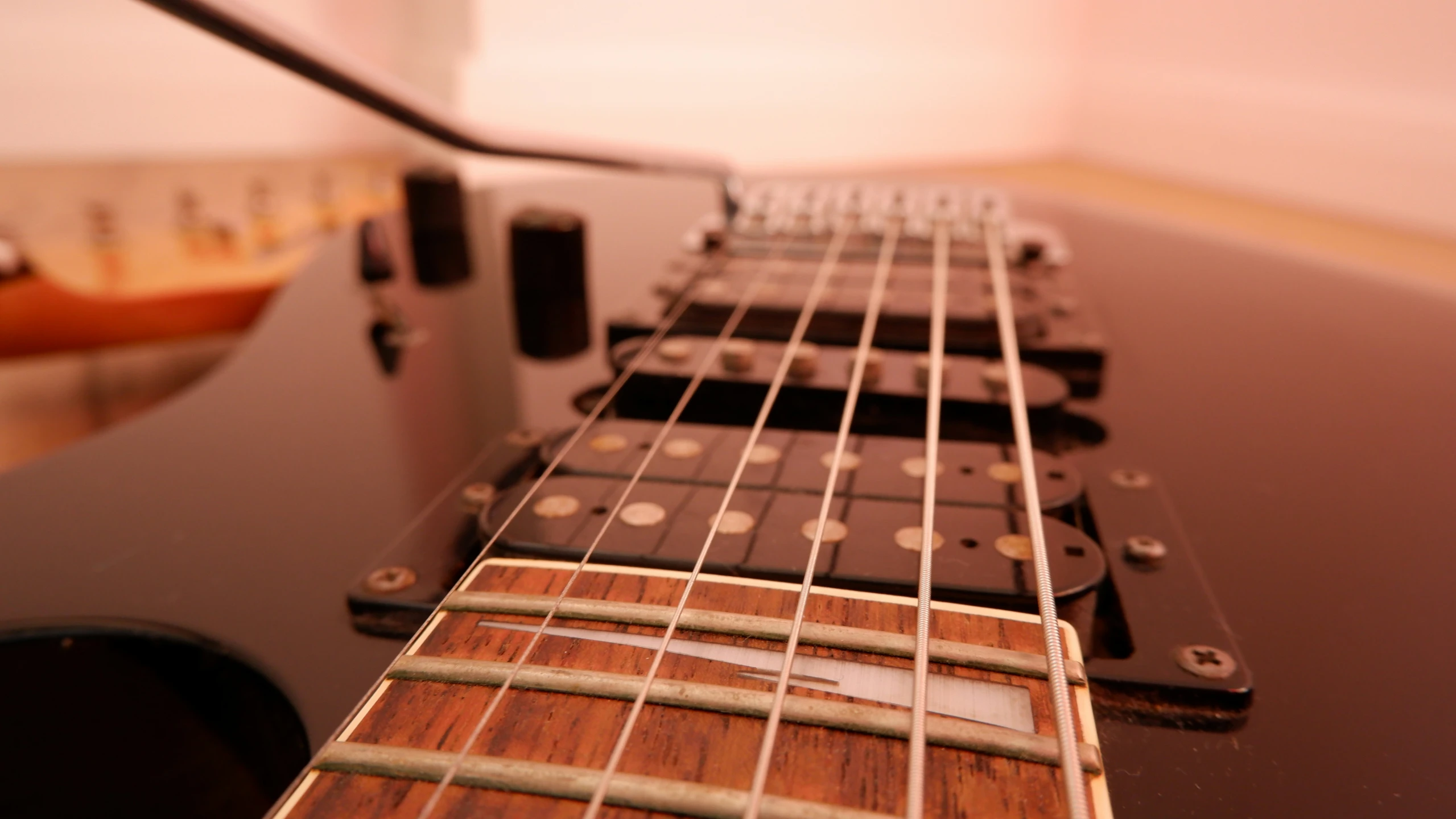 the neck of an acoustic guitar that is on display