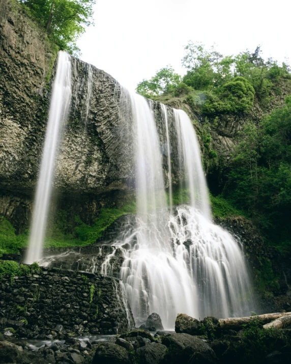 several waterfall cascasing into the air and being blown off