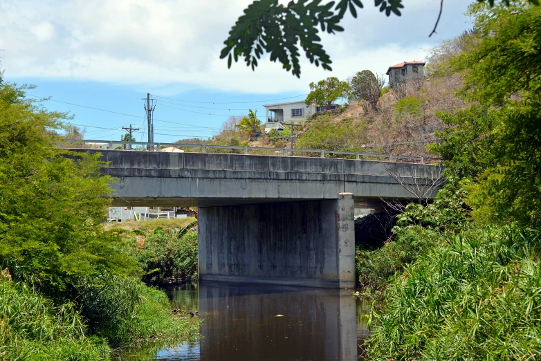 a concrete bridge crossing over a small river