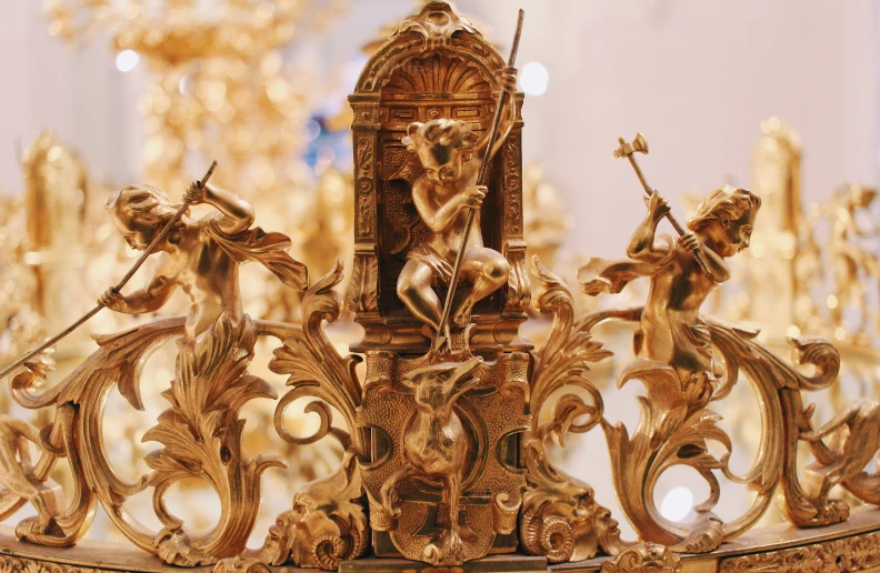 a golden clock is sitting on a stand