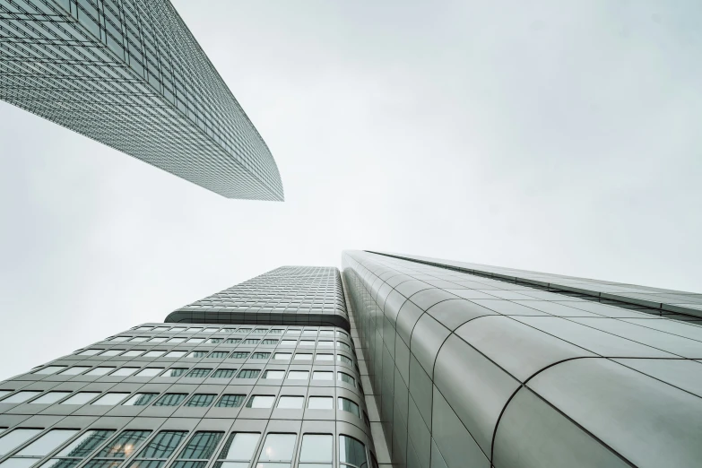 an upward view from the ground looking up into a skyscr