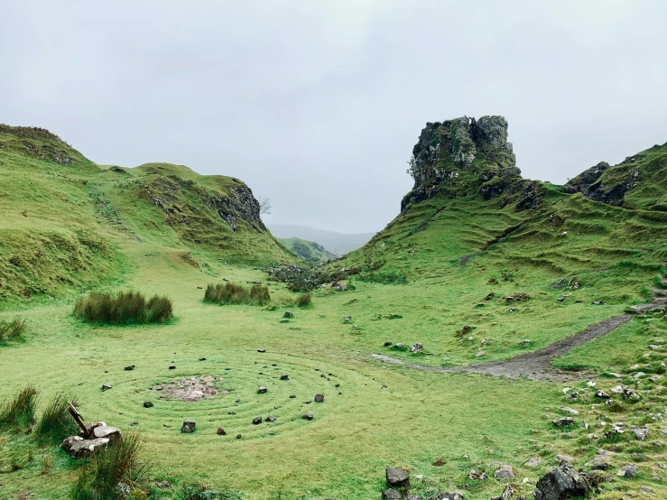 there is an old, worn, green landscape at the top of this hill