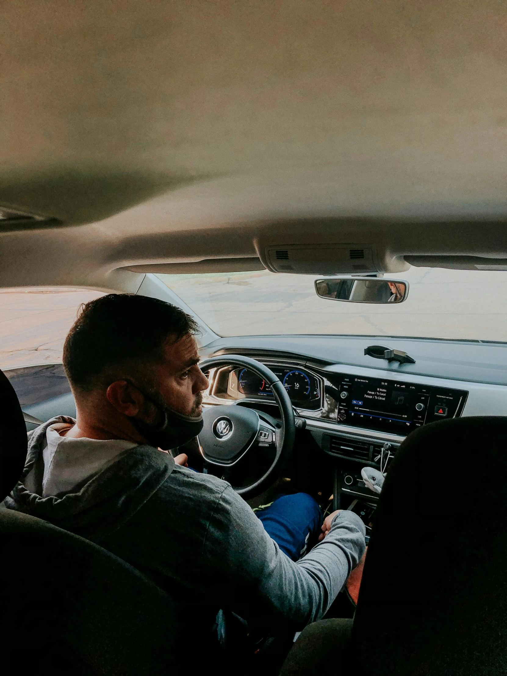 a man driving down a road with his head up