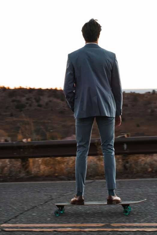 the man is standing on the skateboard with his feet apart