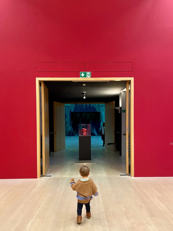 a little boy standing in a large open area