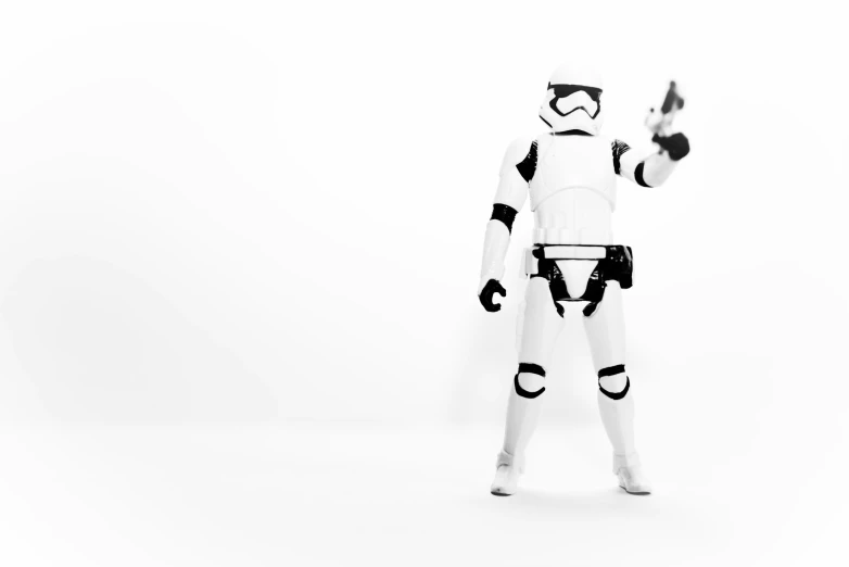 storm trooper standing holding his hand up while holding soing