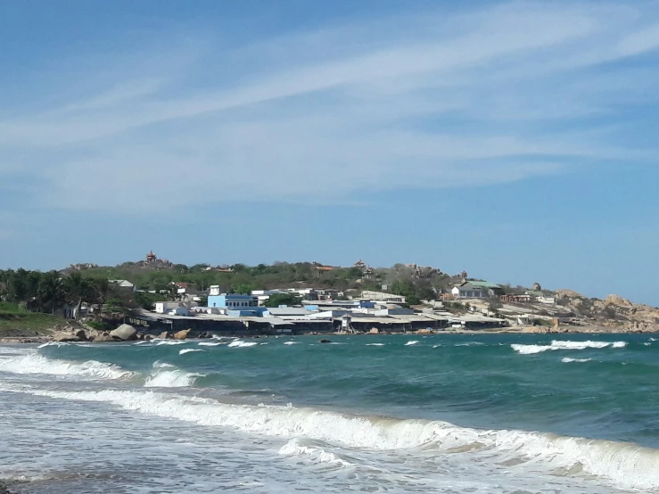 a group of boats sailing on top of the ocean