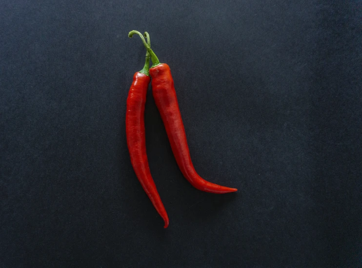 an orange chili with a green pepper