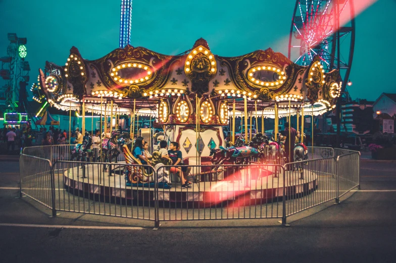 a carnival ride with several riders and two lights