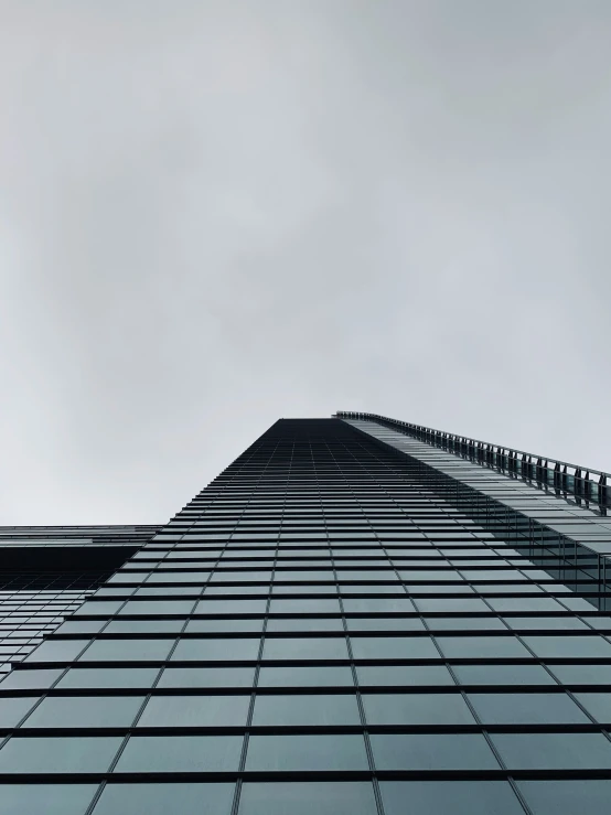 looking up at the face of a glass skyscr