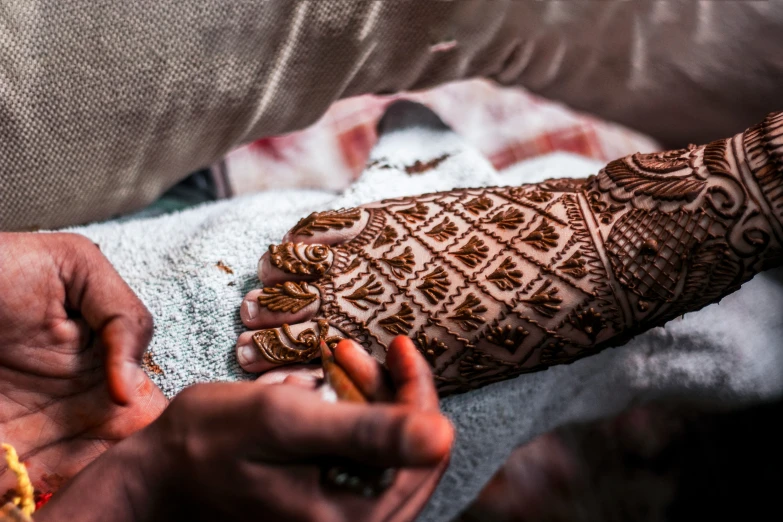 a bride is holding her hand out with henna on it