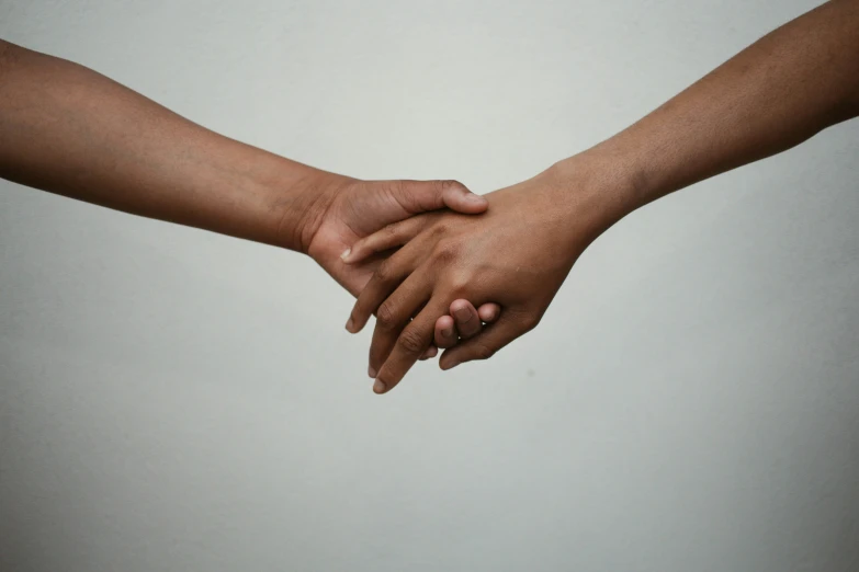 two people hold their hands in one hand