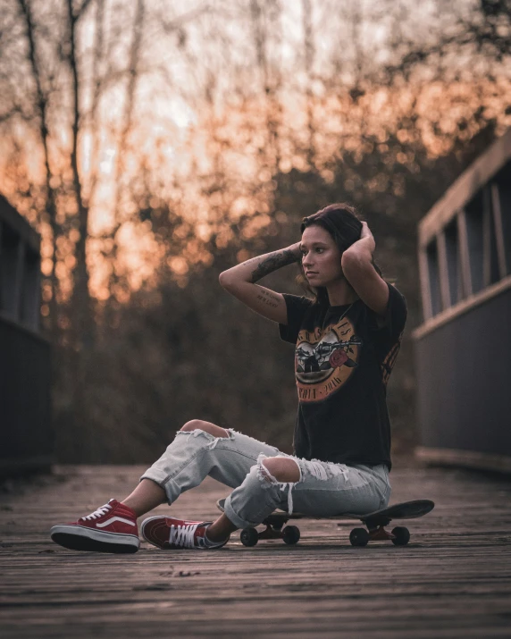 a young person laying on a skateboard next to another one