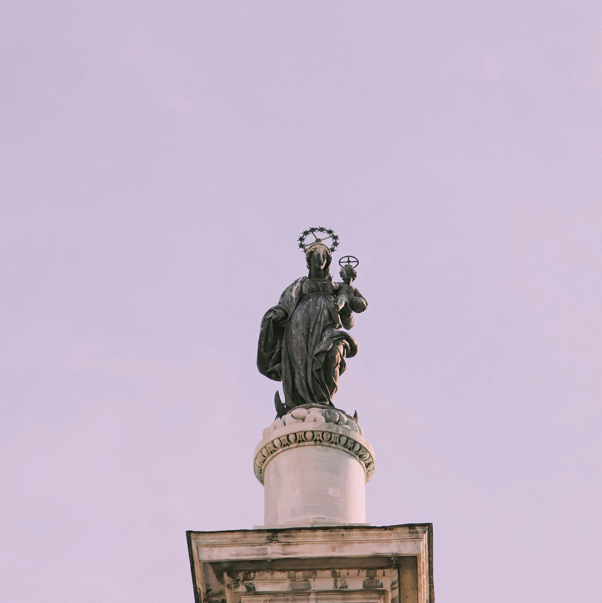 a statue is shown on top of a building