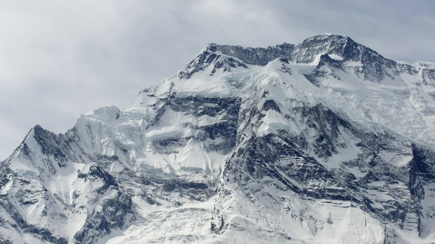 a view of a mountain side covered in snow