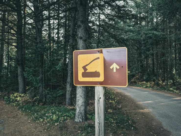 a sign directing motorists to hike in the woods