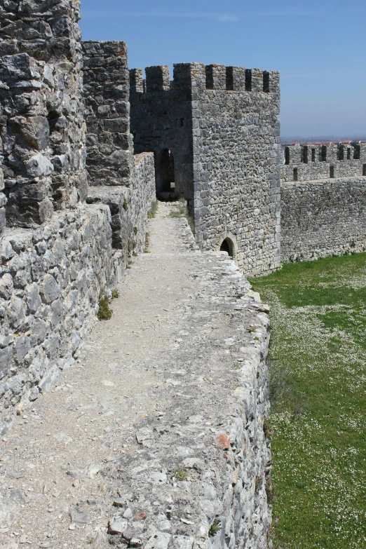 an image of a stone castle gate in the day