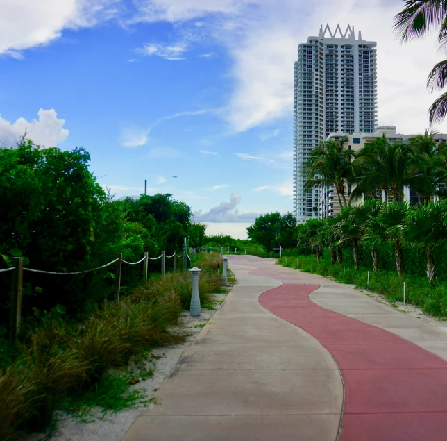 an empty walkway is shown along a city park