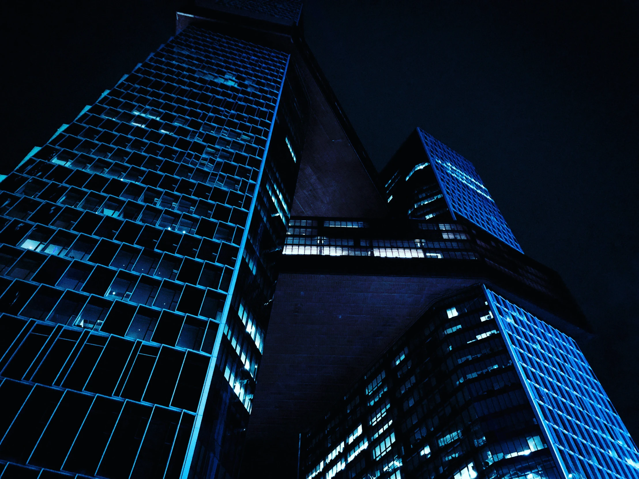 an image of two tall buildings in the night time