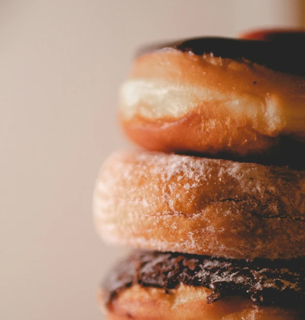 three donuts stacked up in front of each other