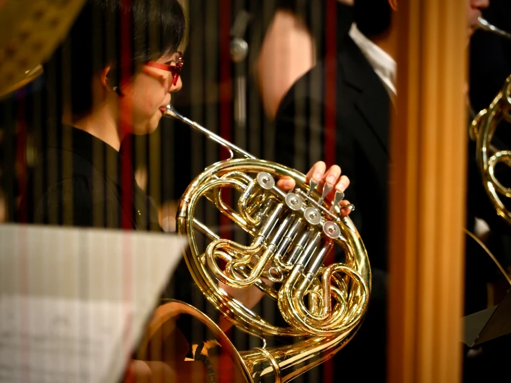 a close up of a person playing a french horn