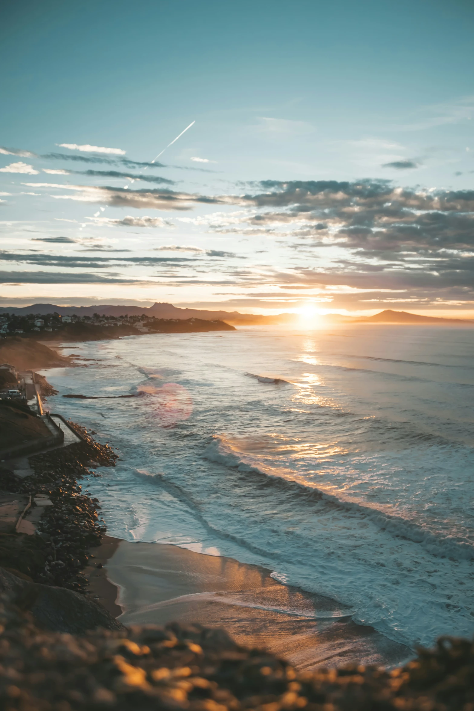 a beach during sunset near the ocean