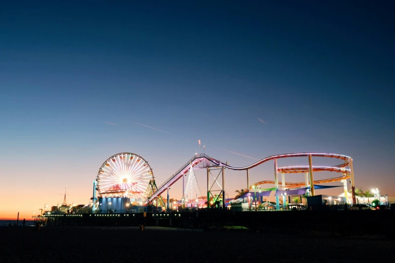 amut rides at dusk, the lights show and people on a beach