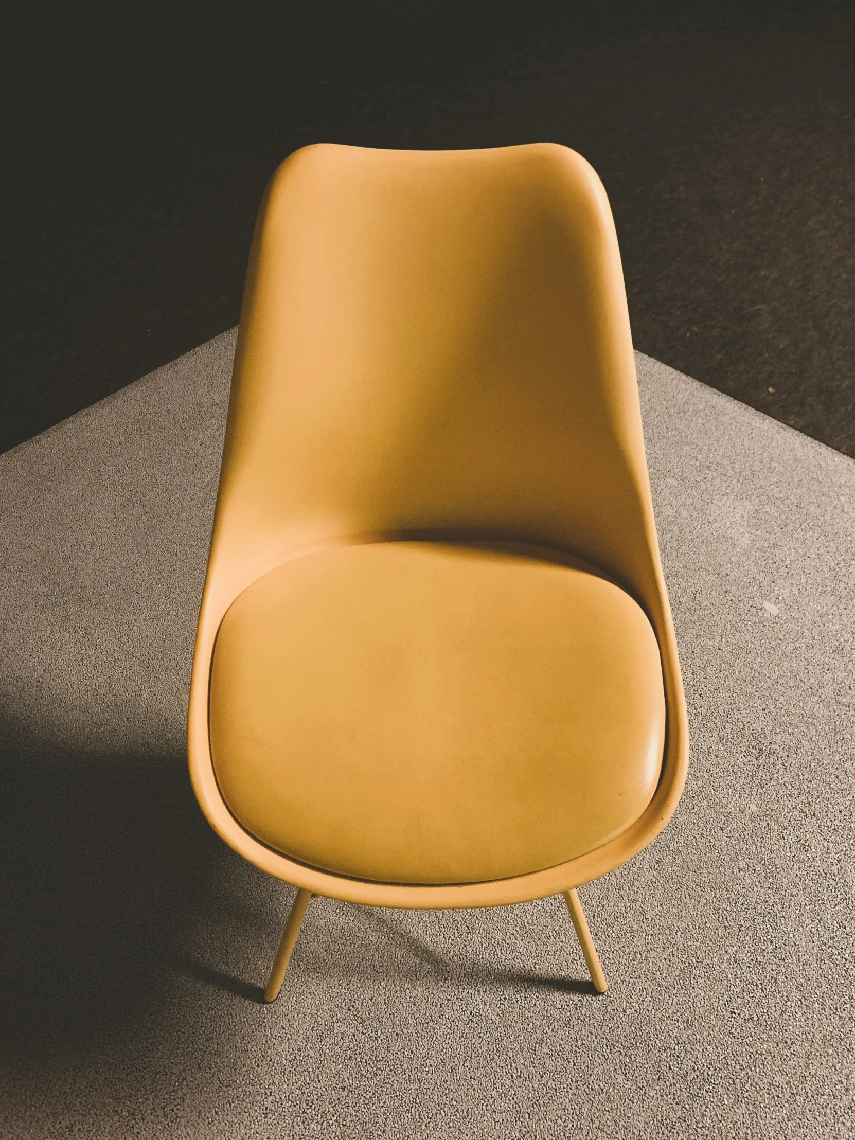 a yellow chair sitting on top of a carpet