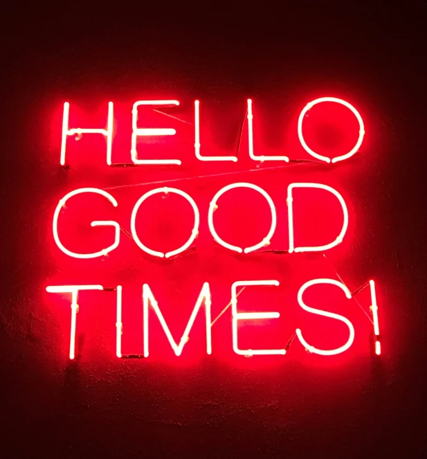 a sign that says hello good times, on a wall