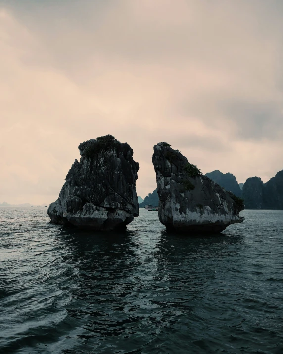 two rocks in the water near one another