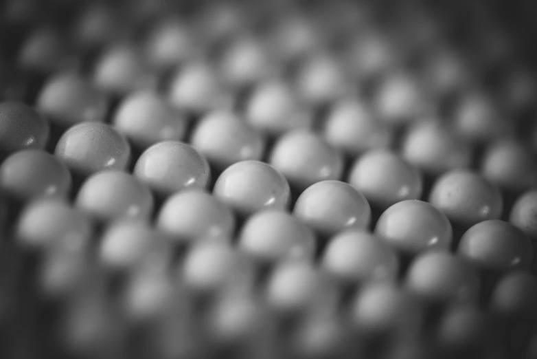 small balls of white color being placed in an array