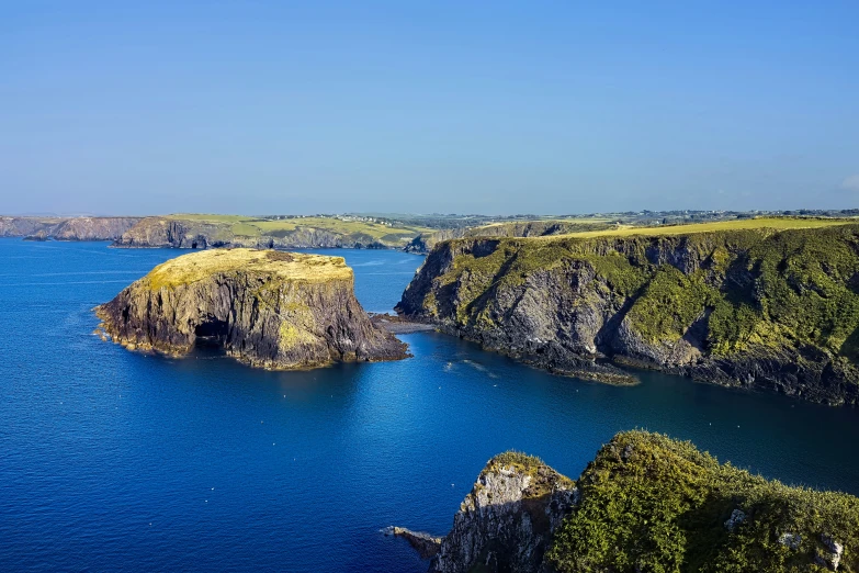 aerial po showing blue water and rocky coastline