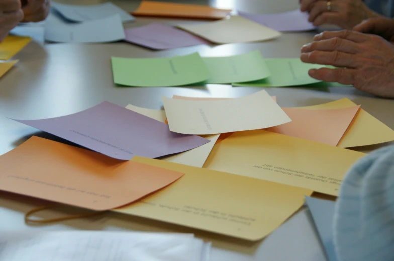 a group of people with some papers in each hand