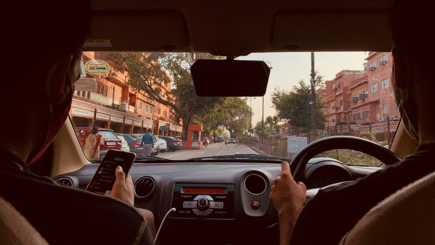 a person that is sitting in the passenger seat of a car