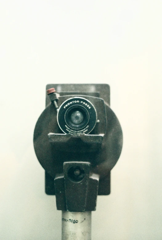 an old fashioned camera on a pole