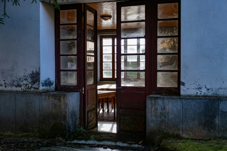 an open door leading into an empty, run down building