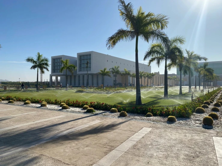 there is a large building with lots of trees on the side of the road